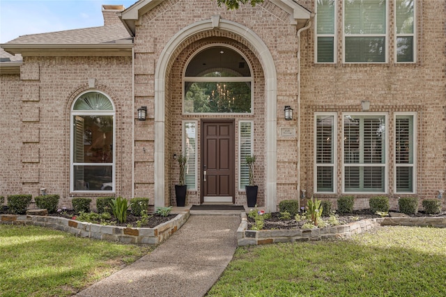 4524 Tuscany Dr, Plano, TX 75093 - doorway to property featuring brick siding, a yard, and a shingled roof