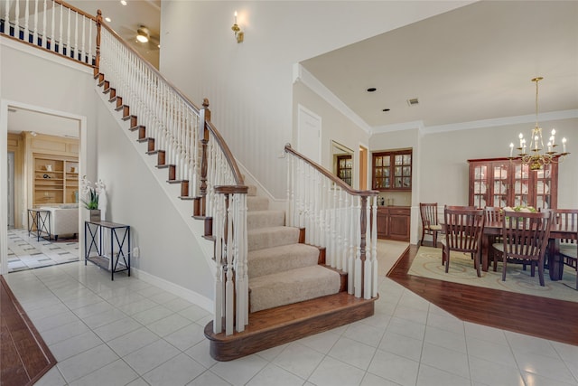 4524 Tuscany Dr, Plano, TX 75093 - staircase with tile patterned flooring, crown molding, a chandelier, and baseboards