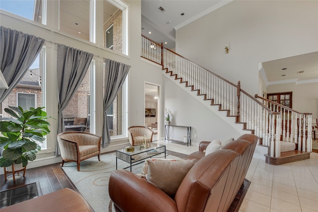 4524 Tuscany Dr, Plano, TX 75093 - living area with stairs, a towering ceiling, plenty of natural light, crown molding, and baseboards