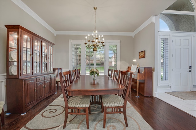 4524 Tuscany Dr, Plano, TX 75093 - dining area with a chandelier, dark wood-style floors, and ornamental molding