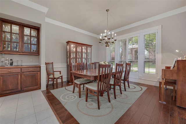 4524 Tuscany Dr, Plano, TX 75093 - dining space featuring a chandelier, ornamental molding, and light wood finished floors
