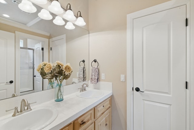 full bath featuring double vanity, ornamental molding, and a sink