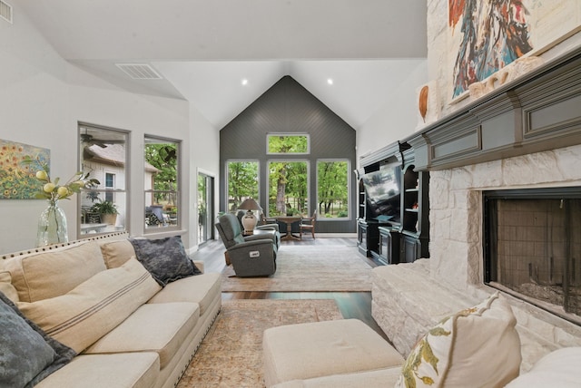 living room with visible vents, recessed lighting, high vaulted ceiling, wood finished floors, and a fireplace