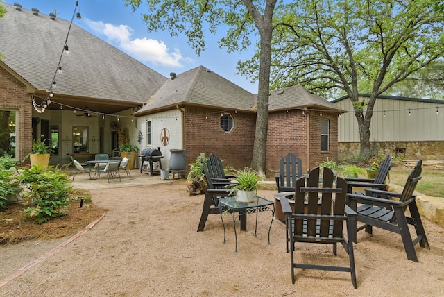 view of patio featuring a fire pit, a grill, and a ceiling fan