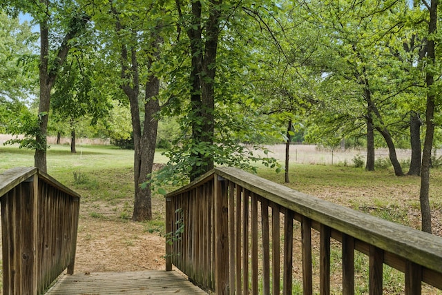 wooden deck featuring a lawn