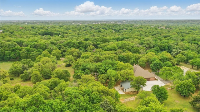 drone / aerial view featuring a view of trees