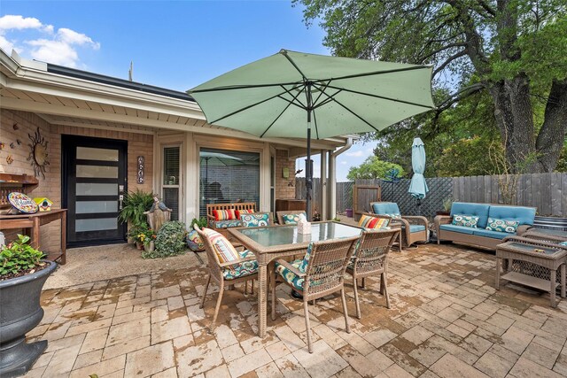 view of patio / terrace with outdoor dining area, outdoor lounge area, and fence