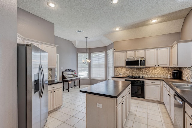 2611 Logan Dr, Mansfield, TX 76063 - kitchen featuring black appliances, dark countertops, light tile patterned floors, tasteful backsplash, and a textured ceiling
