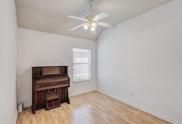 2611 Logan Dr, Mansfield, TX 76063 - unfurnished room with vaulted ceiling, light wood-style floors, a textured ceiling, ceiling fan, and baseboards