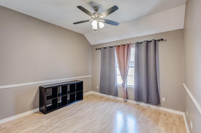 2611 Logan Dr, Mansfield, TX 76063 - empty room featuring wood finished floors, ceiling fan, lofted ceiling, and baseboards