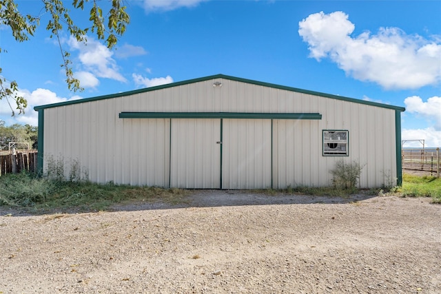 view of pole building with fence