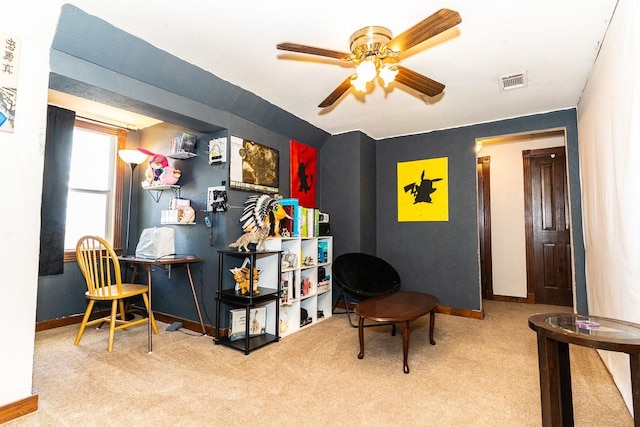living area with ceiling fan, baseboards, visible vents, and carpet