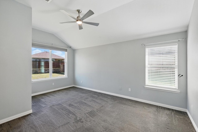empty room featuring ceiling fan, vaulted ceiling, baseboards, and carpet