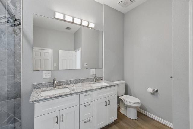 full bath featuring visible vents, toilet, and a sink