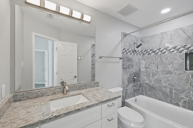 bathroom with shower / bath combination, visible vents, vanity, and toilet
