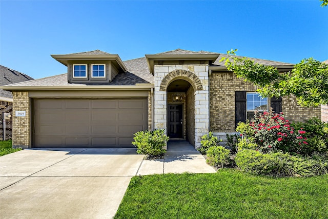 5019 Flanagan Dr, Forney, TX 75126 - view of front of house featuring a garage, brick siding, driveway, and roof with shingles