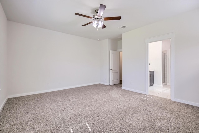5019 Flanagan Dr, Forney, TX 75126 - unfurnished bedroom featuring light colored carpet, baseboards, ensuite bath, and ceiling fan