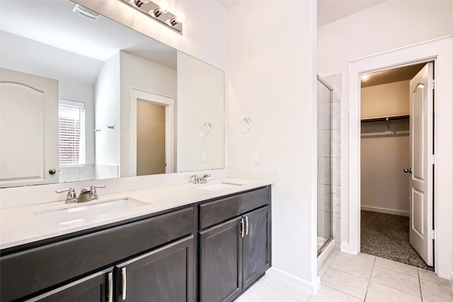 5019 Flanagan Dr, Forney, TX 75126 - bathroom with a shower stall, tile patterned floors, a walk in closet, and double vanity