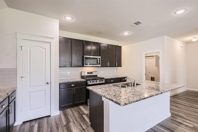 5019 Flanagan Dr, Forney, TX 75126 - kitchen with stainless steel appliances, a sink, dark wood-type flooring, light stone counters, and recessed lighting