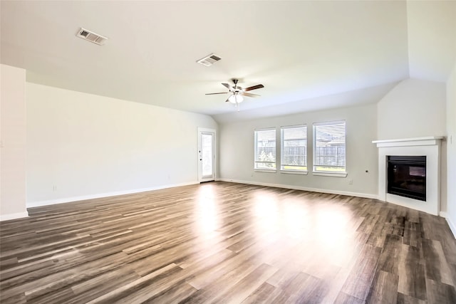 5019 Flanagan Dr, Forney, TX 75126 - unfurnished living room with ceiling fan, dark wood-style flooring, a glass covered fireplace, lofted ceiling, and baseboards