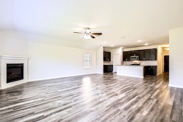 5019 Flanagan Dr, Forney, TX 75126 - unfurnished living room featuring ceiling fan, wood finished floors, a glass covered fireplace, baseboards, and recessed lighting
