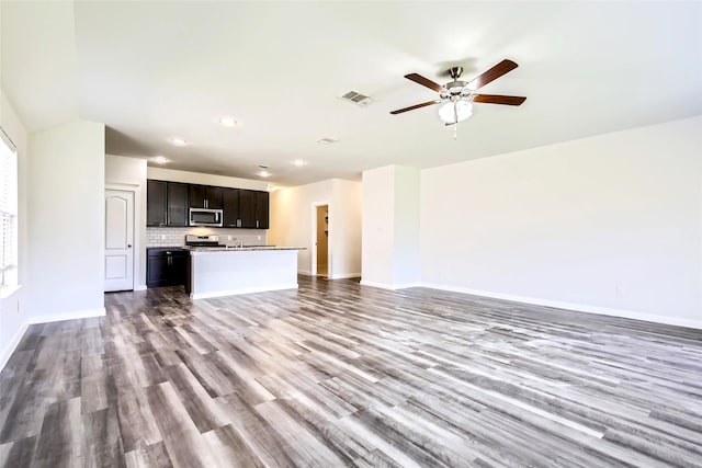 5019 Flanagan Dr, Forney, TX 75126 - unfurnished living room featuring wood finished floors, recessed lighting, a ceiling fan, and baseboards