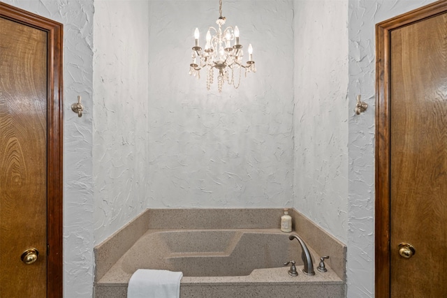 bathroom featuring a garden tub and a notable chandelier