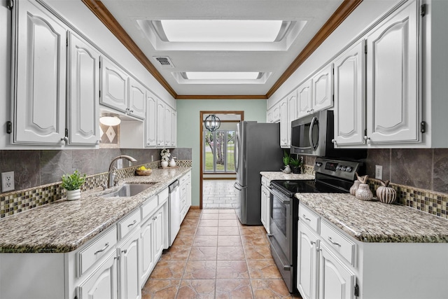 kitchen with appliances with stainless steel finishes, decorative backsplash, crown molding, and a sink