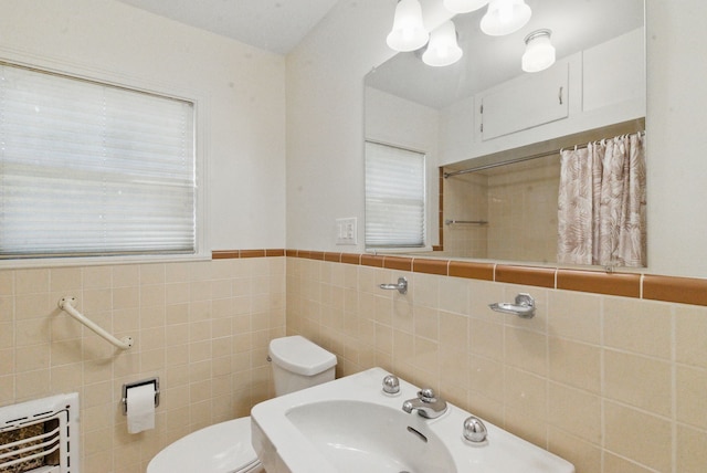 bathroom featuring a sink, heating unit, tile walls, toilet, and a shower with shower curtain