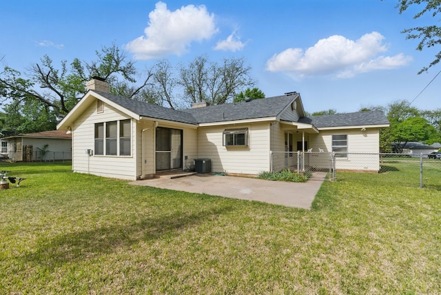 rear view of property featuring central AC, a chimney, fence, a patio area, and a lawn