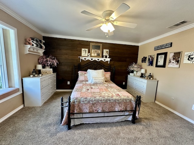 carpeted bedroom featuring baseboards, visible vents, and ornamental molding