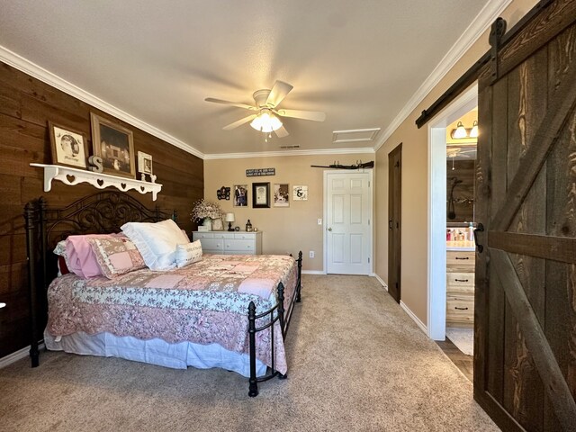bedroom with a ceiling fan, visible vents, crown molding, a barn door, and carpet floors