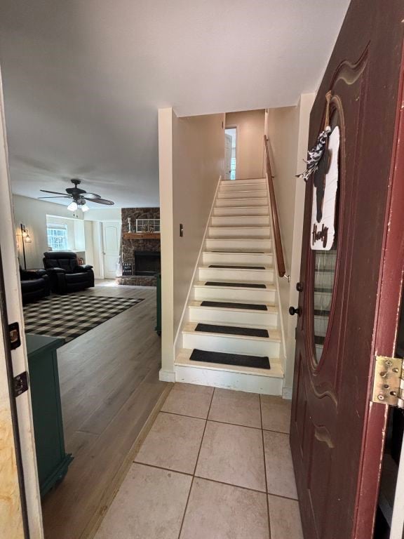 450 Vz County Road 4814, Ben Wheeler, TX 75754 - stairs featuring a stone fireplace, wood finished floors, and ceiling fan