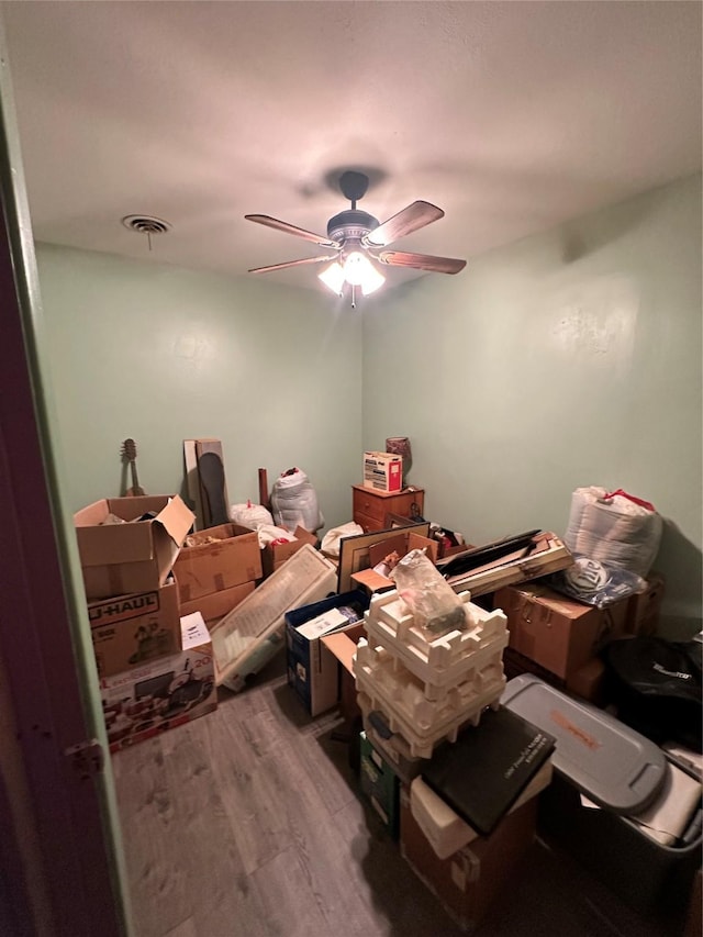 interior space with a ceiling fan and wood finished floors