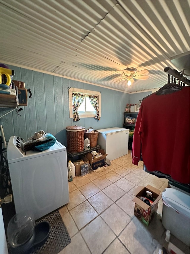 washroom featuring tile patterned floors, a ceiling fan, washer and dryer, and laundry area
