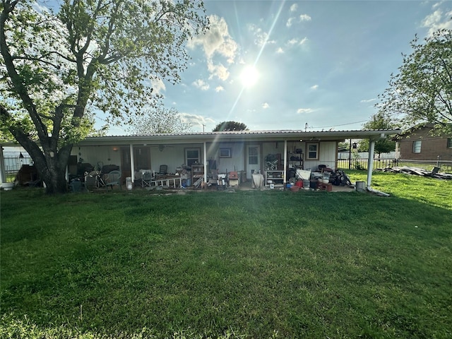 rear view of property featuring fence, a yard, and a patio