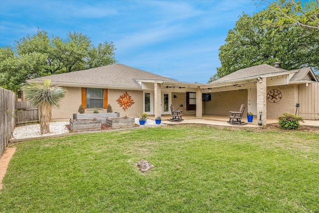 back of house with a patio area, brick siding, fence, and a yard
