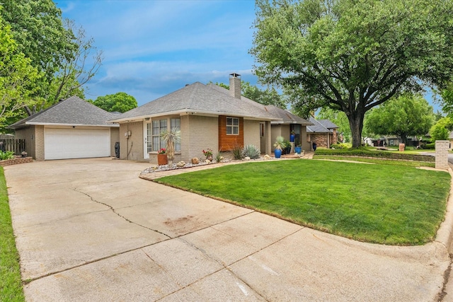 single story home with a front lawn, a chimney, concrete driveway, brick siding, and a garage
