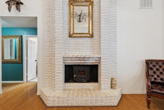 interior details featuring wood finished floors, visible vents, and baseboards