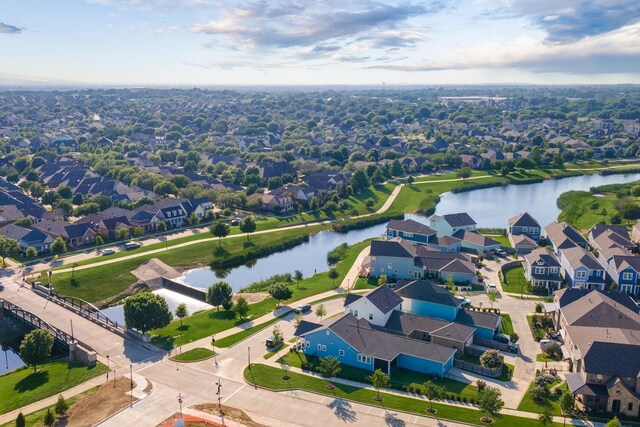 drone / aerial view featuring a water view and a residential view