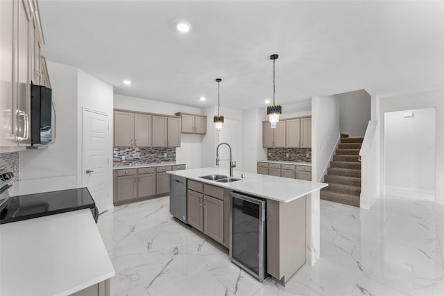 kitchen with backsplash, appliances with stainless steel finishes, beverage cooler, and a sink