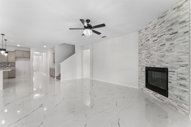 unfurnished living room with ceiling fan, marble finish floor, a fireplace, baseboards, and recessed lighting