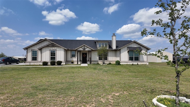 2267 County Road 4010, Decatur, TX 76234 - modern farmhouse style home with board and batten siding, a chimney, and a front yard