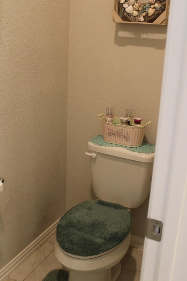 2267 County Road 4010, Decatur, TX 76234 - bathroom with tile patterned flooring, toilet, and baseboards