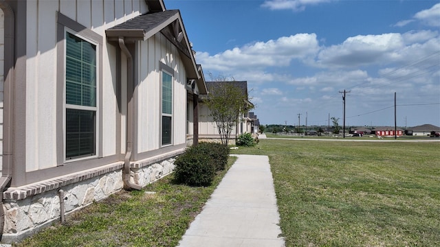 2267 County Road 4010, Decatur, TX 76234 - view of side of home with a lawn, board and batten siding, and roof with shingles