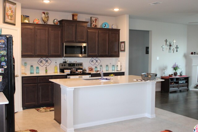 2267 County Road 4010, Decatur, TX 76234 - kitchen with appliances with stainless steel finishes, a sink, light countertops, decorative backsplash, and recessed lighting