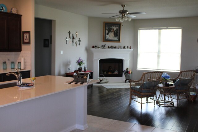 2267 County Road 4010, Decatur, TX 76234 - living area with ceiling fan, a fireplace with raised hearth, and dark wood finished floors