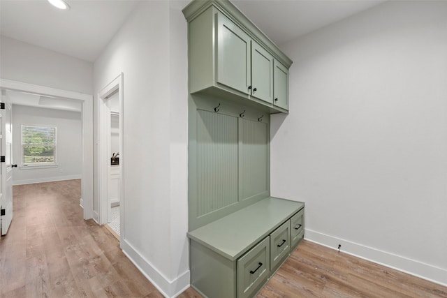 mudroom with recessed lighting, light wood-style flooring, and baseboards