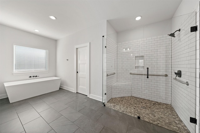 bathroom with a soaking tub, baseboards, recessed lighting, and a stall shower