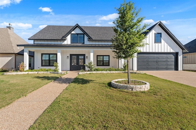 modern inspired farmhouse with concrete driveway, board and batten siding, a standing seam roof, french doors, and roof with shingles